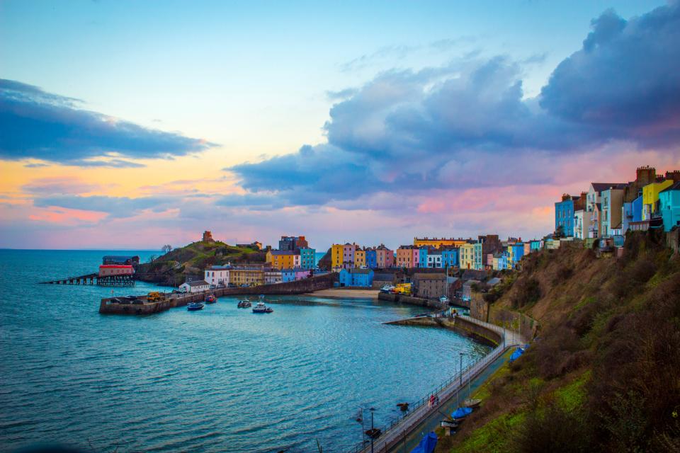 An evening shot of Tenby harbour overlooked by colourful houses