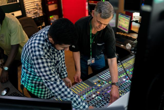 Two men working at a sound engineering desk