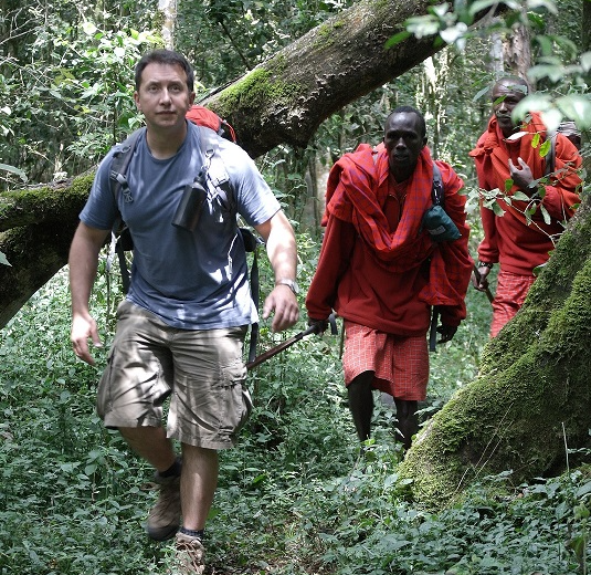 Rhys Jones walking through the forest with local guides