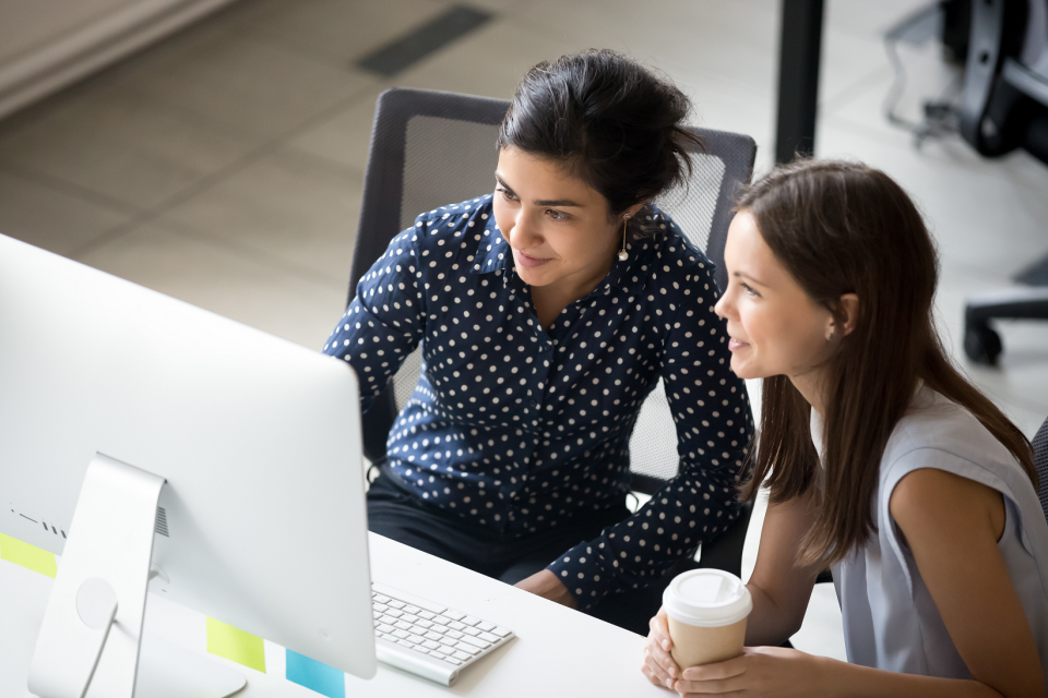 Two women sat at a computer