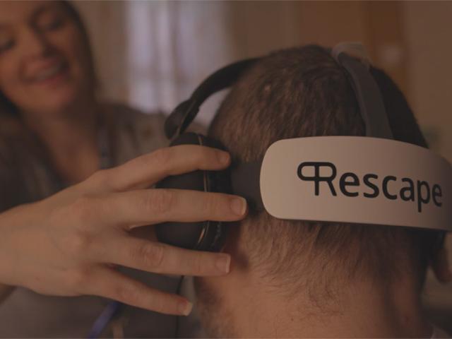 Woman placing a VR headset on a man